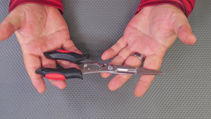 Review of Longnose Pliers: Features stainless steel construction, a grippy rubber handle, lanyard holes, strong spring, long nose for de-hooking fish, and integrated scissors for cutting braid, fishing line, and wire.