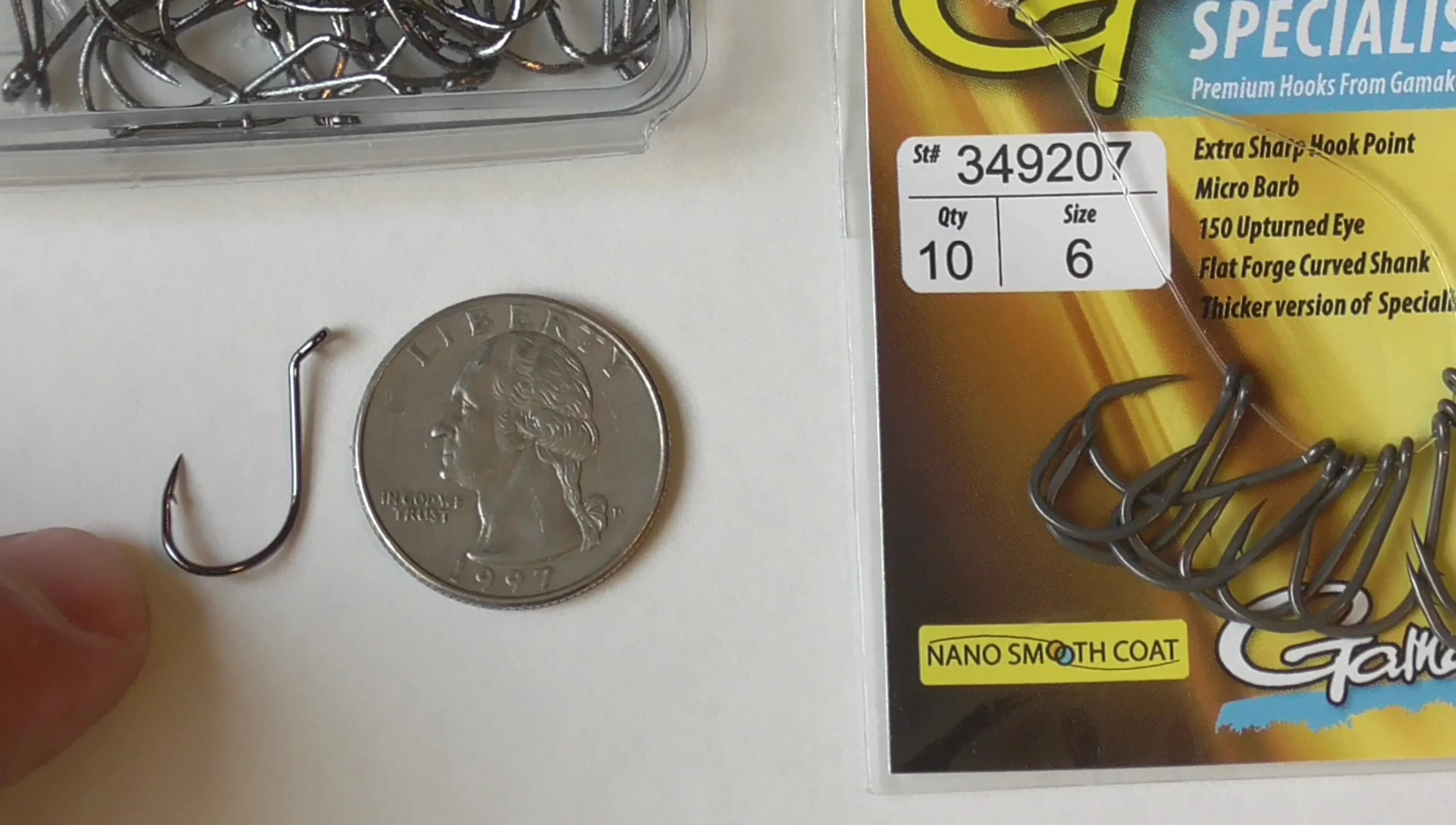 Laser Sharp size 4 hook next to a quarter.