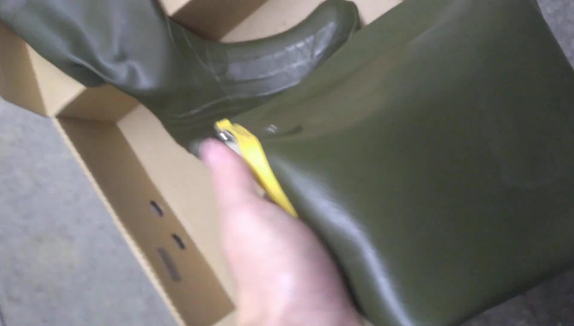 Hand touching the wader material, demonstrating its texture.