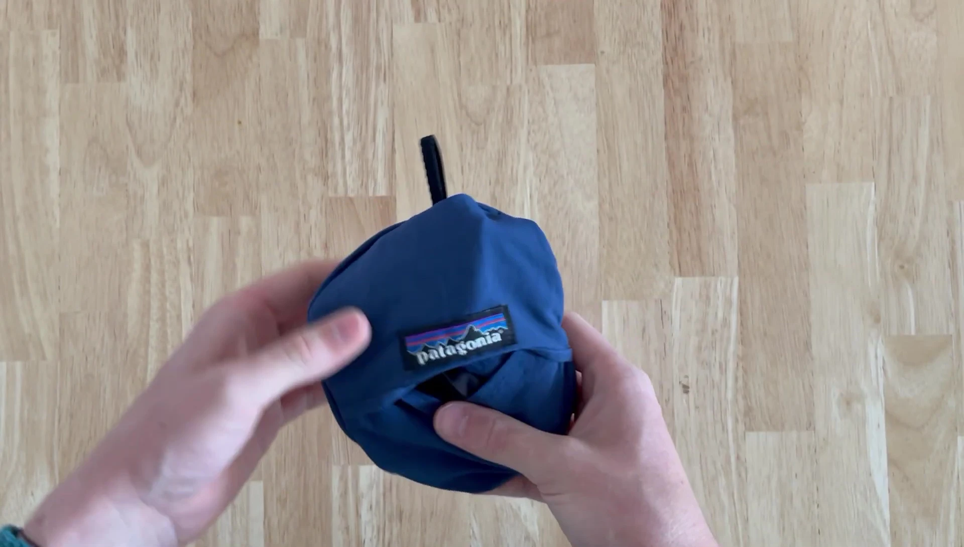 The hat clipped onto the fishing bag.