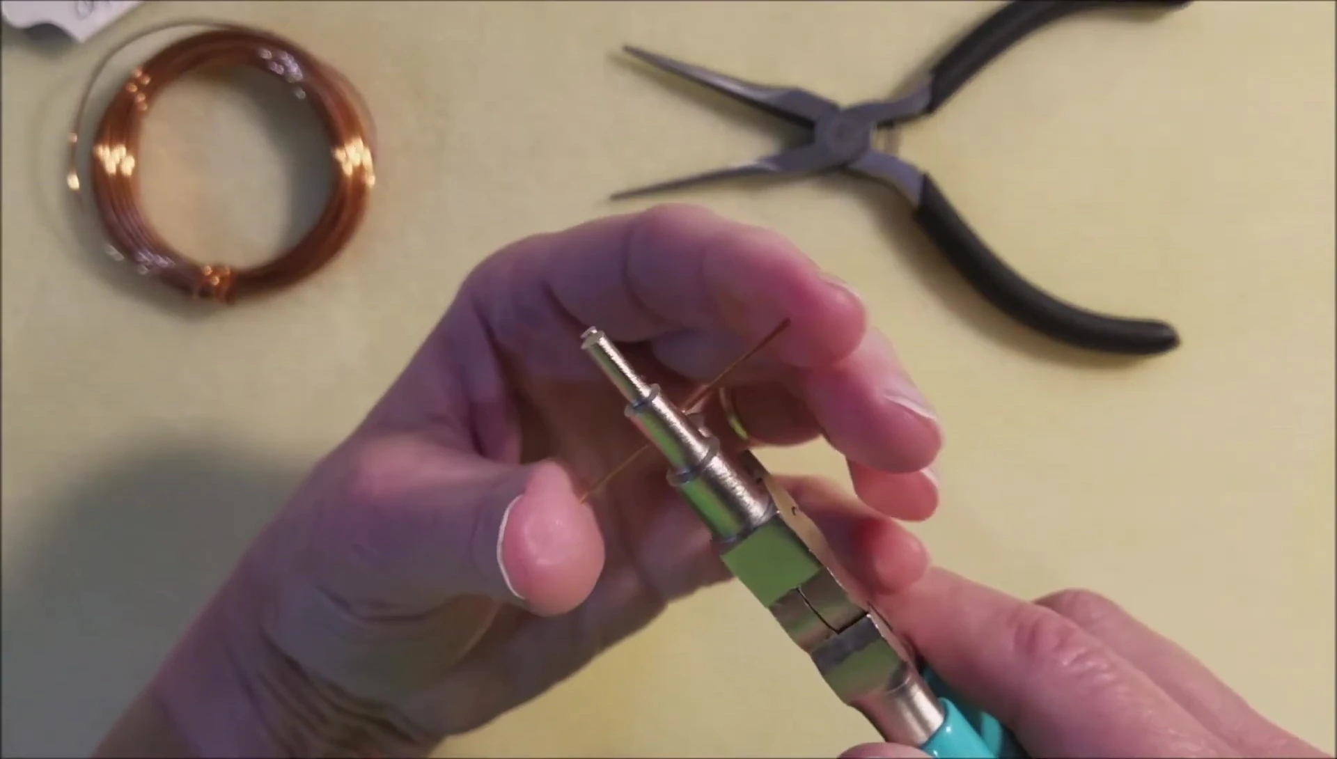 Using the jump ring maker to create the bend in the wire.